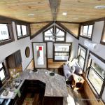The Coyote P-561SL by Platinum Cottages and RRC Athens. this display model cabin features a front porch, large loft, stained exterior, and Blue Ponderosa pine accents throughout