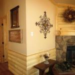 Log interior accents - log wainscot and log above fireplace available to see at Recreational Resort Cottages in Rockwall, Texas