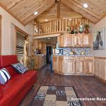 The Timberline 566SLFP model by Platinum Cottages and RRC Athens. This rustic park model cabin is shown with many upgrades including cedar interior pkg with Hickory cabs, a front porch, loft, washer/dryer front loads installed, and more!!